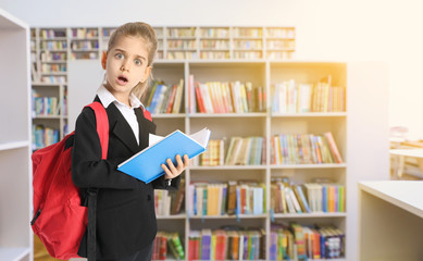 Canvas Print - Shocked little schoolgirl in modern library