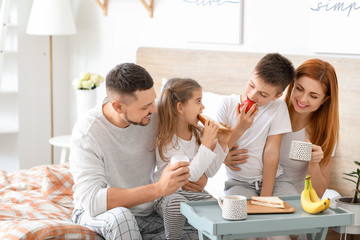 Poster - Happy family having breakfast in bedroom at home