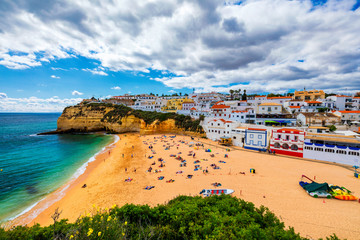 View of Carvoeiro fishing village with beautiful beach, Algarve, Portugal. View of beach in Carvoeiro town with colorful houses on coast of Portugal. The village Carvoeiro in the Algarve Portugal.