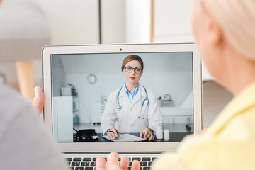 Wall Mural - Couple video chatting with doctor at home