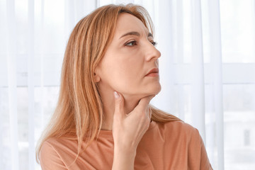 Woman with thyroid gland problem at home