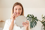 Fototapeta Na sufit - Beautiful young woman removing makeup at home