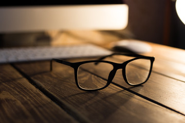 Glasses for sight and vision correction and protection from computer on the wooden table