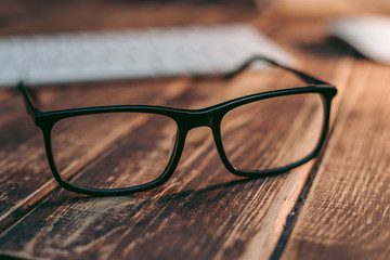 Glasses for sight and vision correction and protection from computer on the wooden table