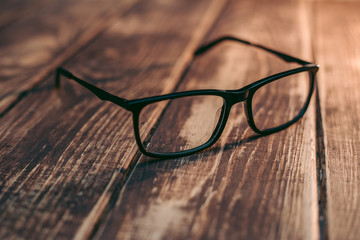 Glasses for sight and vision correction and protection from computer on the wooden table