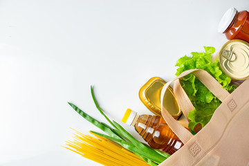 A bag of donated food. The concept of the delivery of necessary foodstuffs on a white background.