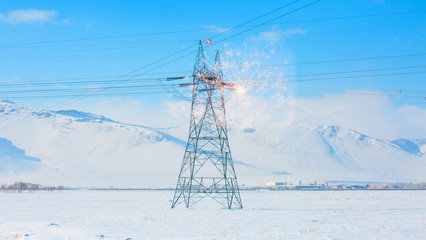 Winter landscape with electric pole in the snow - Electrical short circuit An electrical fault