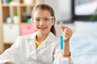 © Syda Productions - education, science and children concept - happy smiling girl in goggles with test tube studying chemistry at home laboratory