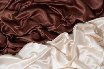 smooth elegant beige and brown background of silk fabric lined with waves