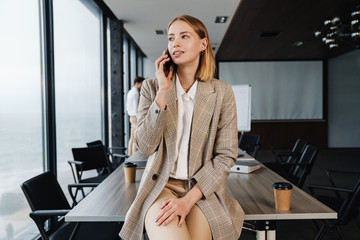 Canvas Print - Beautiful young smart businesswoman standing