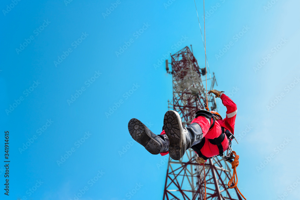 Harness Absailing Rope access Worker on abseiling from high places, wearing full safety ...