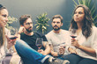 © Mangostar - Happy friends drinking red wine at terrace. Smiling young people talking while sitting on wicker chairs. Leisure, friendship concept