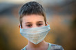 Sad child with safety mask from coronavirus