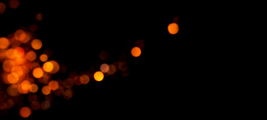 Shiny orange bokeh on a black background