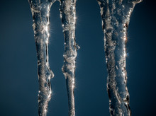 Close-up Of Icicles Against Blue Sky