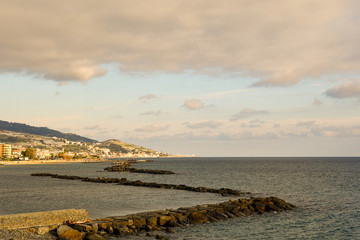 Wall Mural - Scenic view of the bay of Arma di Taggia in the Riviera of Flowers with rocky breakwaters and the coastline in the background, Imperia province, Liguria, Italy