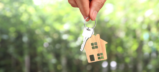 Real estate agent handing over house keys in hand