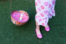 Low Section Of Woman With Easter Basket On Grassy Field