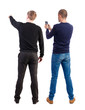 © ghoststone - Back view of two man in sweater with mobile phone.