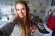 © artiemedvedev - Fashion blogger woman in jeans and turtleneck showing high heel shoes on camera. Stylist influencer girl showing trendy footwear filming vlog episode for her channel. Opinion leader sets trends.