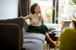© BGStock72 - Young curly hair african woman relaxing at home and using mobile phone