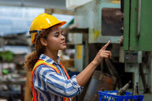 Young Smart Woman Engineer In Safety Helmet Working With Electronic Heavy Industry Machine In Lathe Factory. Professional Female Technician Factory Worker Control Metal Manufacturing Industry