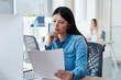 © gpointstudio - Serious woman analyzing some documents