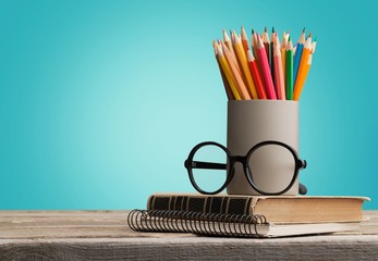 Wall Mural - Stack of vintage books and colorful pencils on the desk