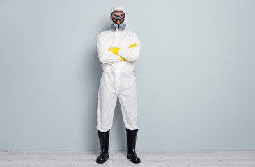 Full body photo of professional guy disinfectant watch public places disinfection arms crossed wear white hazmat protective suit goggles mask gloves gumboots isolated grey color background