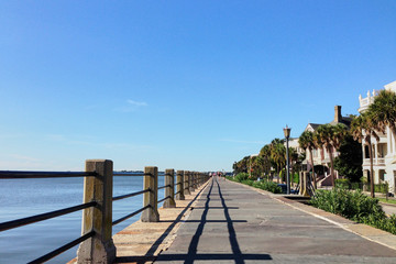  Charleston, South Carolina/USA - Sep 03, 2016: Boardwalk with houses on one side and sea on the other side in Charleston port. Sunny view at the Charleston bay.
