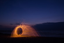 Man Playing With Wire Wool At Night