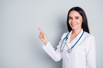 Canvas Print - Disinfect your hands. Photo of beautiful family doc lady assistant virology clinic direct finger empty space show banner rules safety wear lab coat stethoscope isolated grey color background