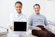 © LIGHTFIELD STUDIOS - selective focus of smiling african american dentist holding digital tablet with blank screen near happy patient