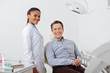 © LIGHTFIELD STUDIOS - selective focus of happy patient smiling with cheerful african american dentist in braces