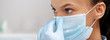 © LIGHTFIELD STUDIOS - panoramic shot of african american dentist touching medical mask