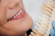 © LIGHTFIELD STUDIOS - cropped view of man smiling near teeth palette in clinic