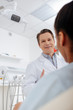 © LIGHTFIELD STUDIOS - selective focus of happy dentist looking at african american patient