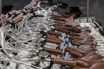 Row of white bicycles stored in bike rental facility