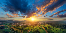 Aerial Panorama Of A Vast Landscape With A Small Town At A Gorgeous Colorful Sunset With Dramatic Sky