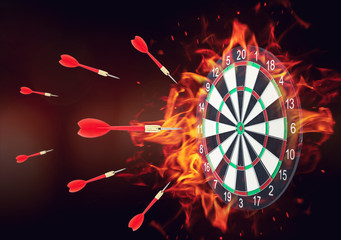 Burning board and darts on dark background