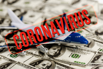 Wall Mural - selective focus of plane model on dollar banknotes, coronavirus illustration