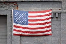 Close-up Of American Flag On Gray Wall
