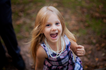 portrait of excited little girl walking outdoors