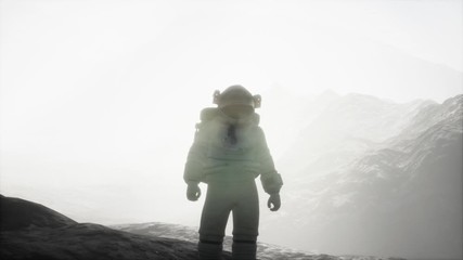 astronaut on another planet with dust and fog