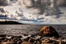 Seascape With Cloudy Dark Sky At Juminda Peninsula. Lighthouse At Other Shore. Baltic Sea, Estonia, Europe.