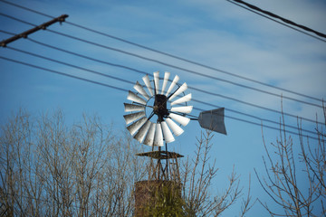 old windmill on a blue sky background