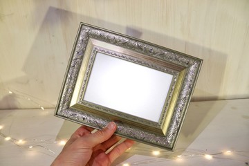 Photo frame in which you need to insert your image. Photo frame on a wooden shelf