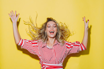 portrait of a beautiful girl. posing on a yellow background. different emotions