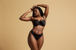 © Indico Studio/ADDICTIVE STOCK - Curvy beautiful African American woman with braids in lingerie with closed eyes against yellow background