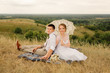 © deineka - The newlyweds on picnic in nature. Bride and groom after wedding ceremony.